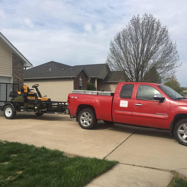 The CS Maintenance truck with the door sign on it, hitched to a trailer